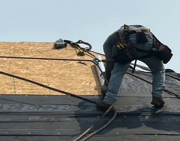 Worker replacing a roof